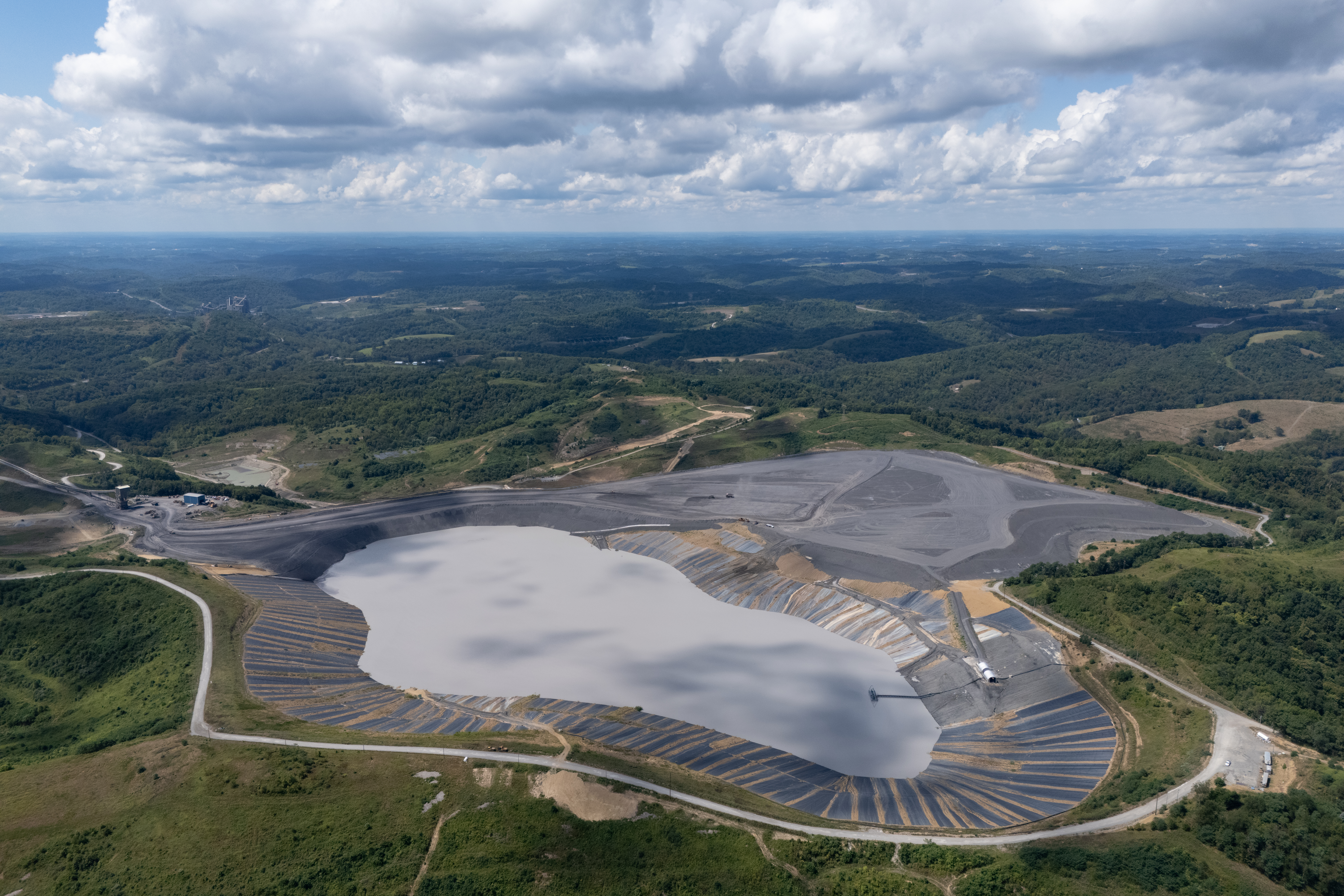 A Coal Refuse Disposal Area (CRDA) at the Pennsylvania Mining Complex. CRDAs hold waste materials from coal mining and preparation, and can pose environmental and health risks. As of 2023, the PAMC has eight CRDAs, covering approximately 3,500 acres of land. A Coal Refuse Disposal Area (CRDA) at the Pennsylvania Mining Complex. CRDAs hold waste materials from coal mining and preparation, and can pose environmental and health risks. As of 2023, the PAMC has eight CRDAs, covering approximately 3,500 acres of land.